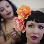 Masuimi Max, right, laughs as she gets a hairstyle by Jennifer Corona during the Tiki Oasis event Friday, Aug. 15, 2014, in San Diego. Hundreds of tiki culture aficionados, clad in tropical colors, gathered Friday for a weekend-long celebration that revels in the movements from the 1950s and 1960s.,Image: 586912858, License: Rights-managed, Restrictions: This content is intended for editorial use only. For other uses, additional clearances may be required., Model Release: no, Credit line: Gregory Bull / AP / Profimedia